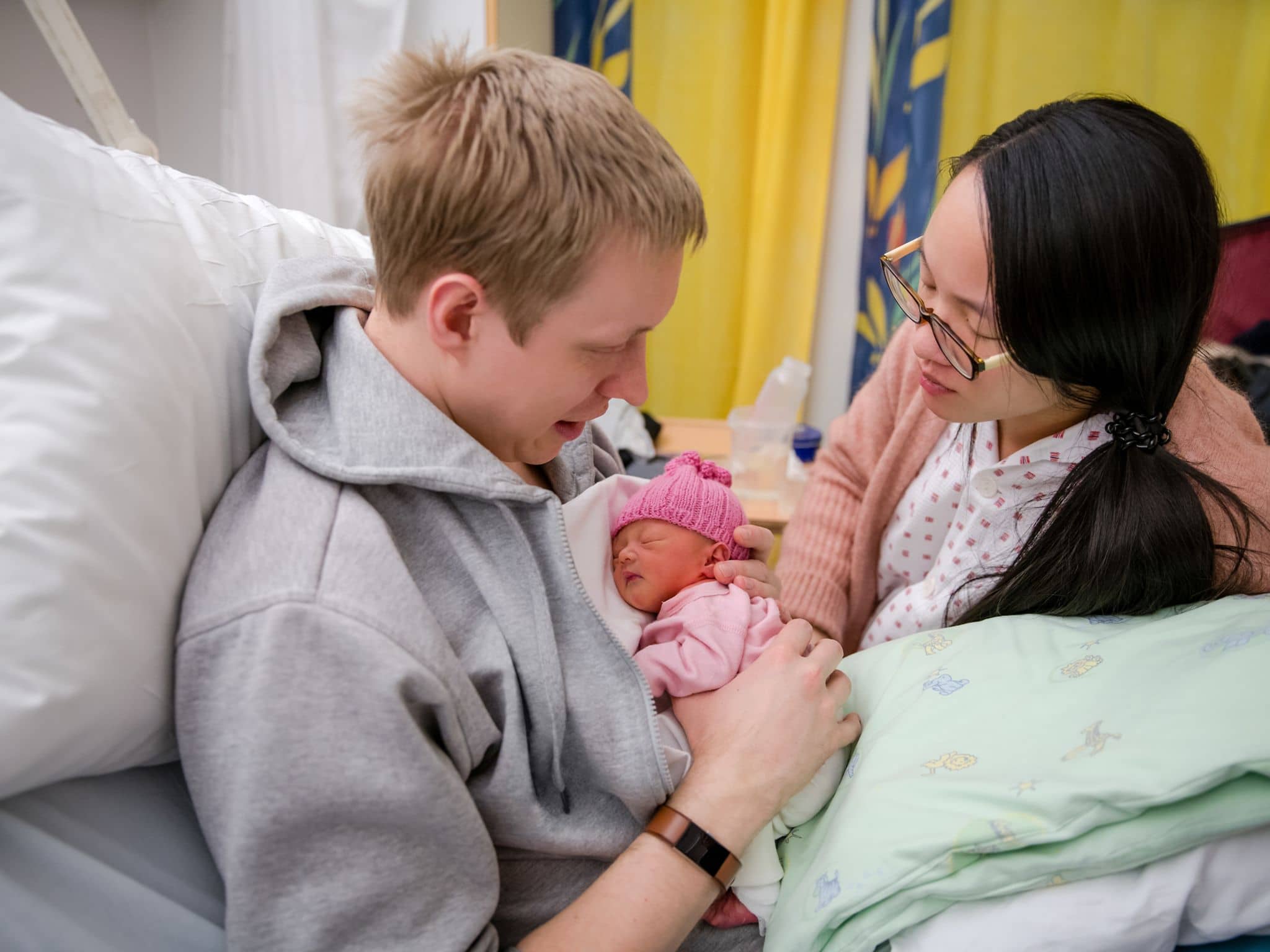 Frühchen: Ein junges Paar hält ihr kleines Neugeborenes im Arm