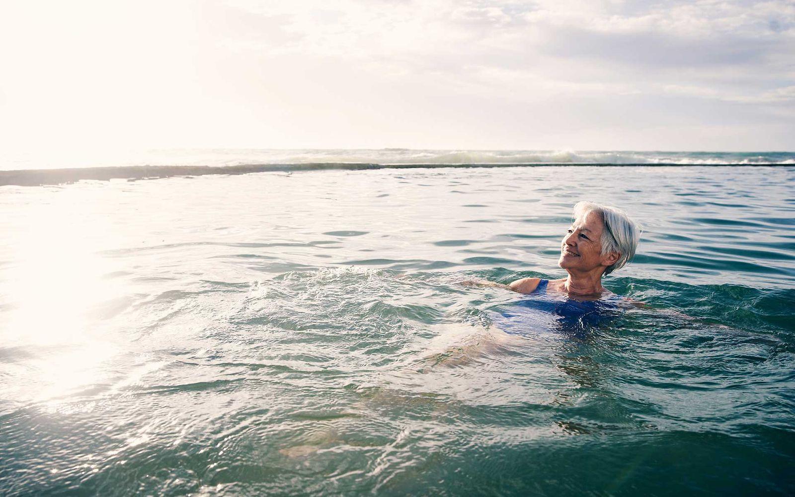 KHK und Sport: Ältere Frau schwimmt in einem See