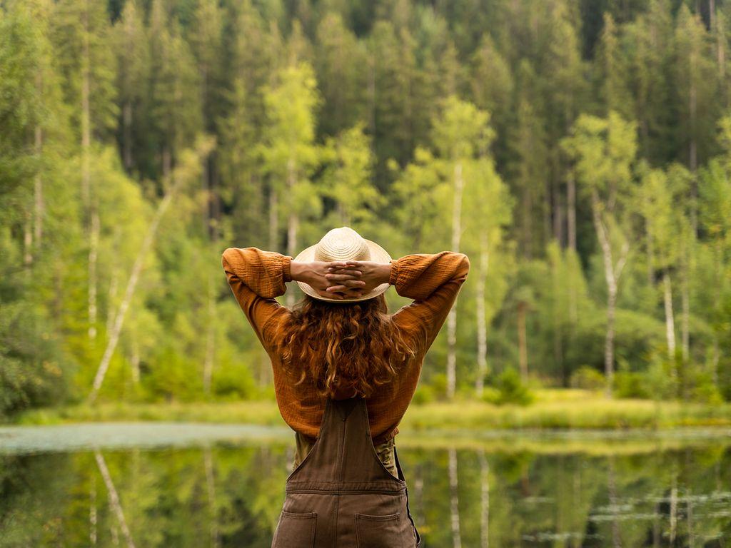 Back view portrait of a woman in the forest.