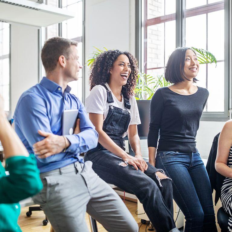 Picture: Colleagues in the office talking to each other and having fun. 