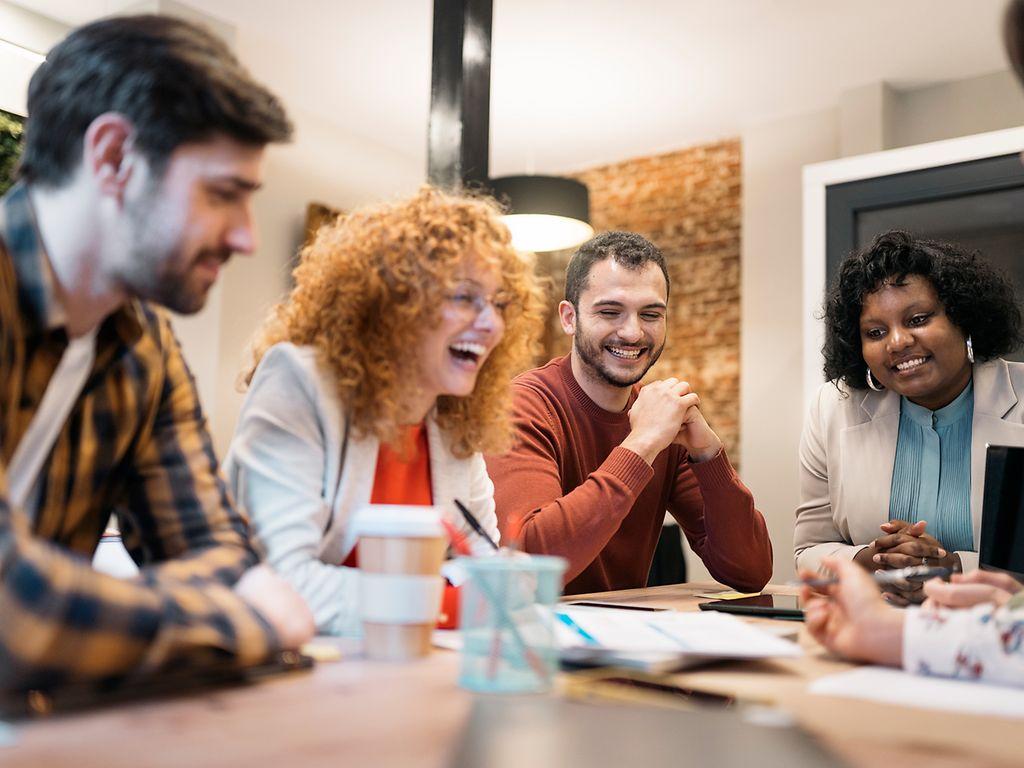 Image: A group of colleauges talking in a meeting.