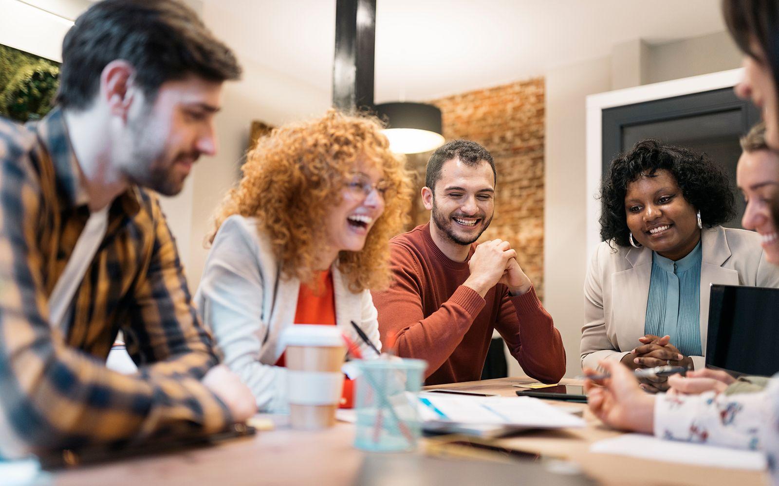 Image: A group of colleauges talking in a meeting.