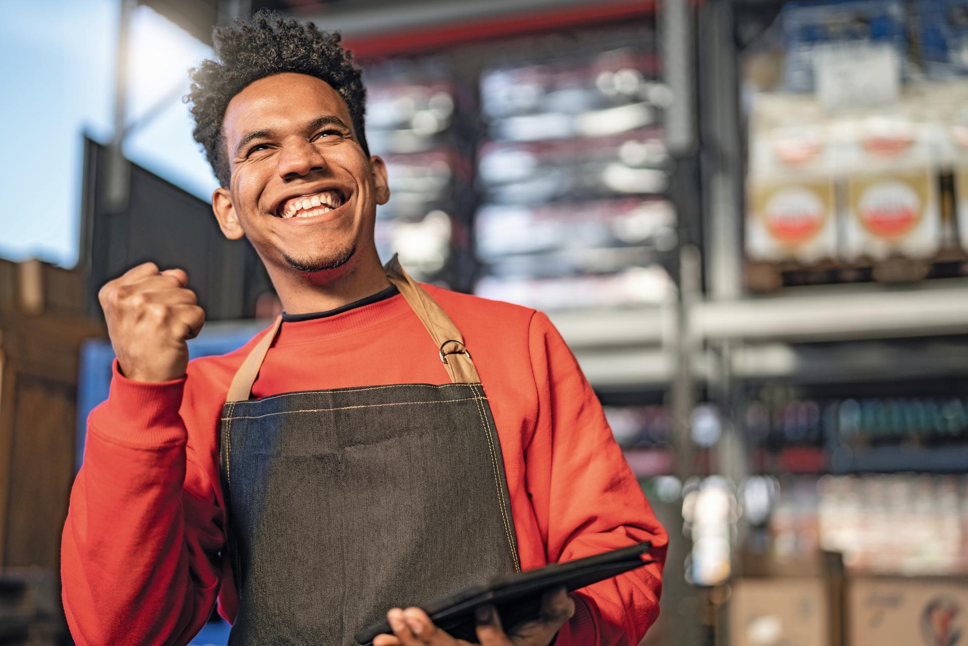 Image: Young man with tablet is happy and laughing.