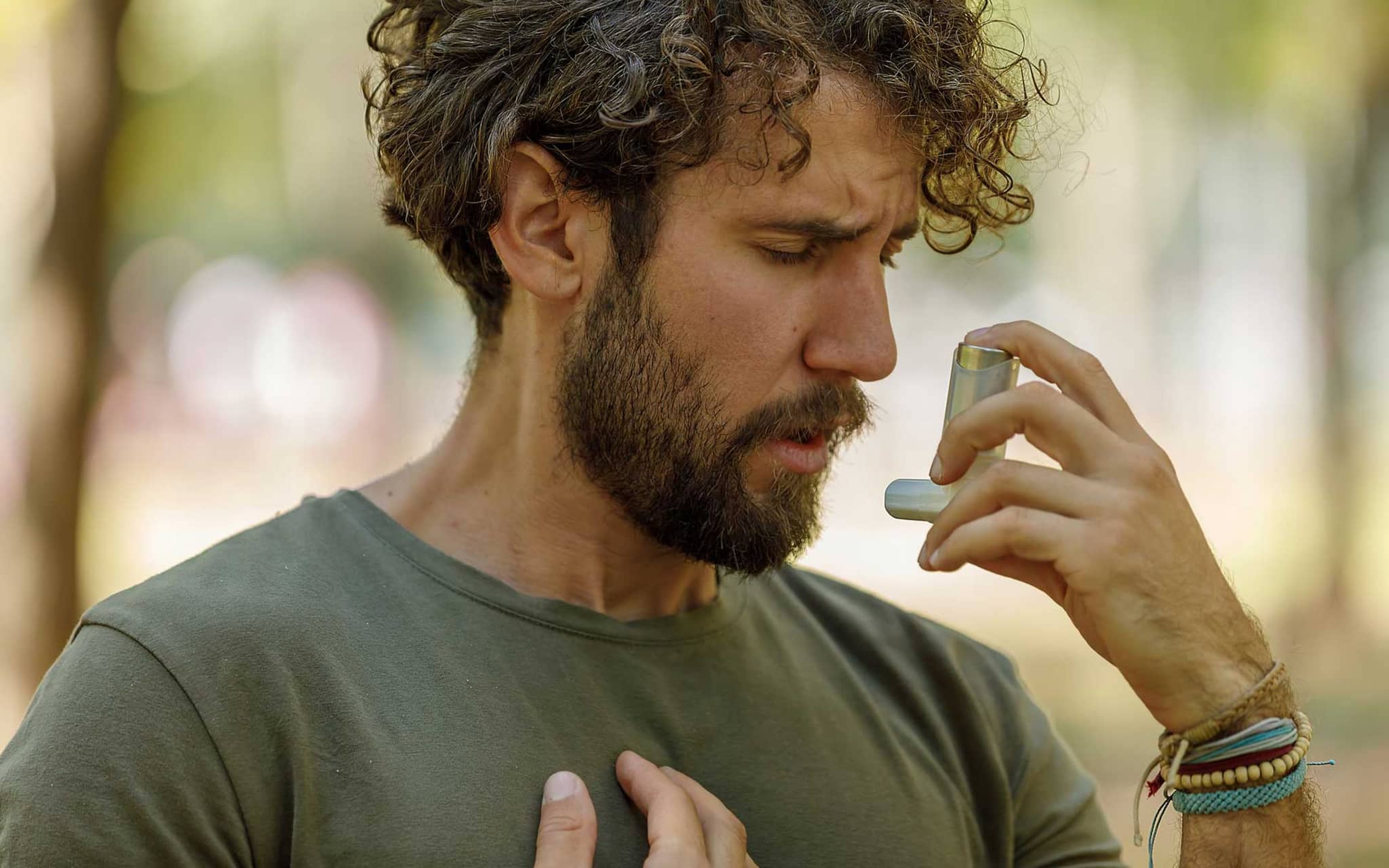 Symbolbild Asthmaanfall: Mann nutzt Inhalator